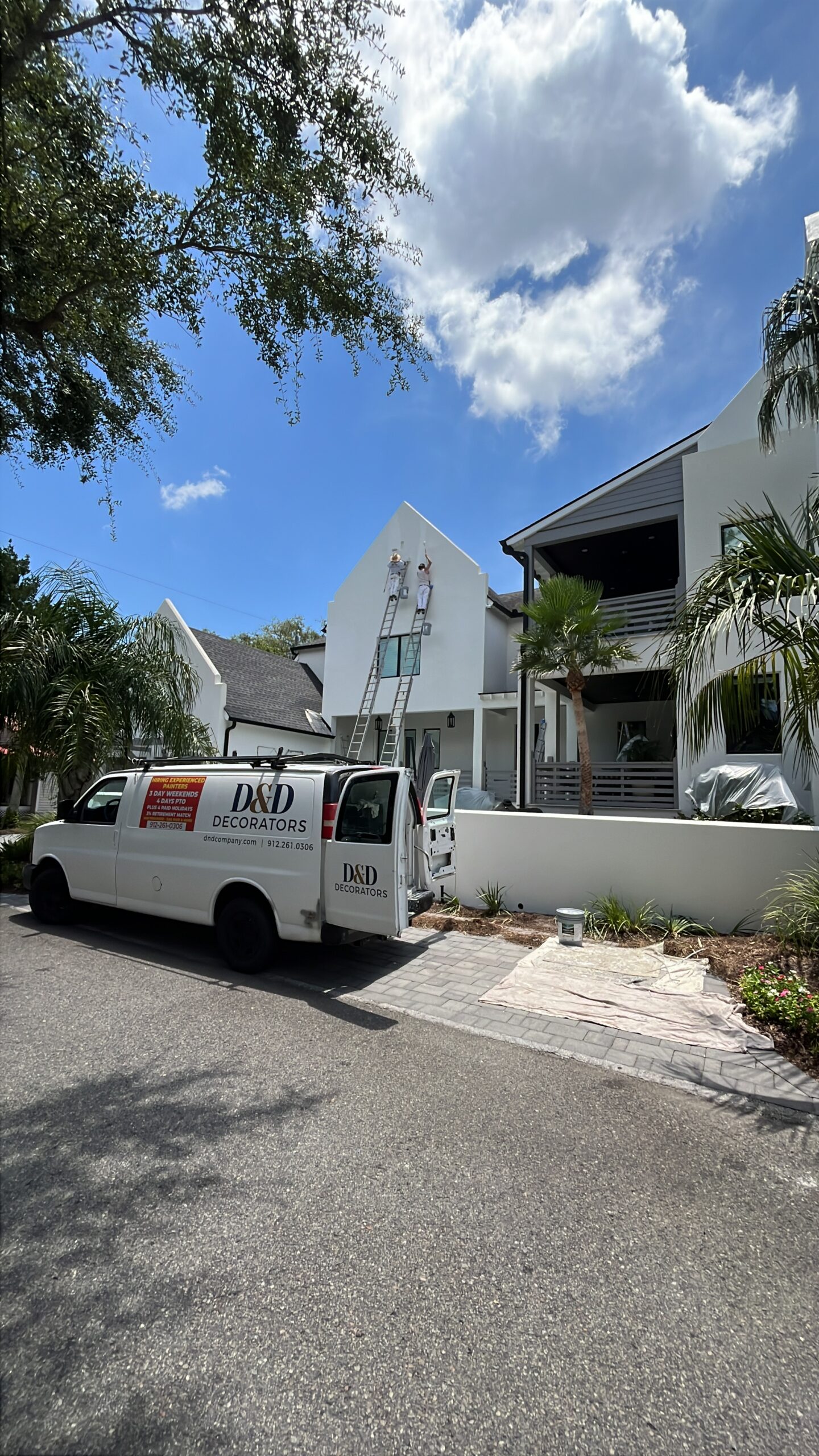 D&D Decorators crew applying paint to a home exterior