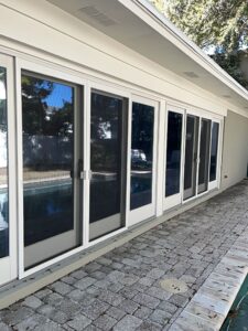 Freshly painted white exterior glass doors along a residential patio