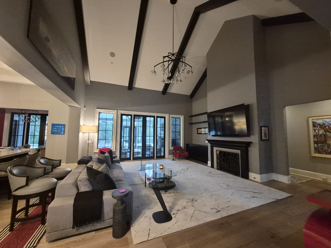 Gray great room with vaulted ceiling and dark beams painted by D&D Decorators