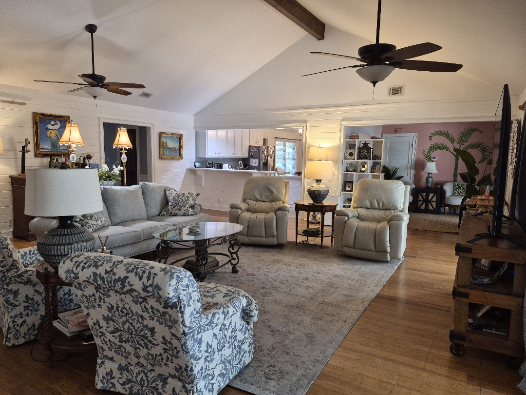 Living room with painted shiplap walls and vaulted ceiling