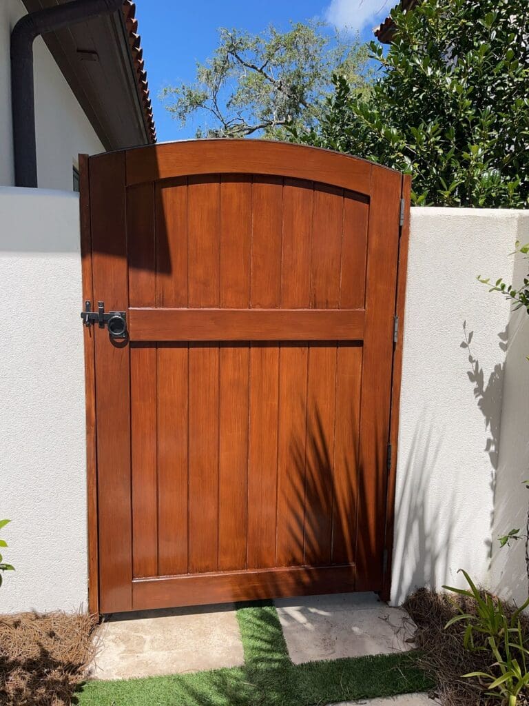 Stained wood garden gate with vertical panels on a St. Simons Island property