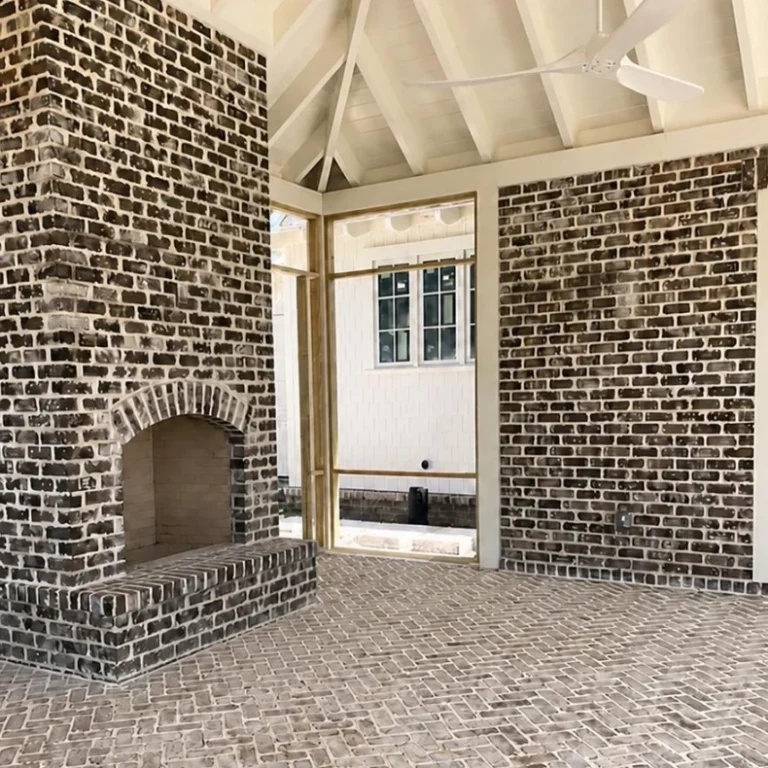 Whitewashed brick fireplace on a covered patio