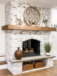 Whitewashed brick fireplace with exposed brick texture and natural wood mantel