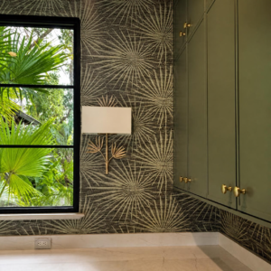 Dark botanical wallpaper with olive green built-in cabinets, black window trim and brass hardware.