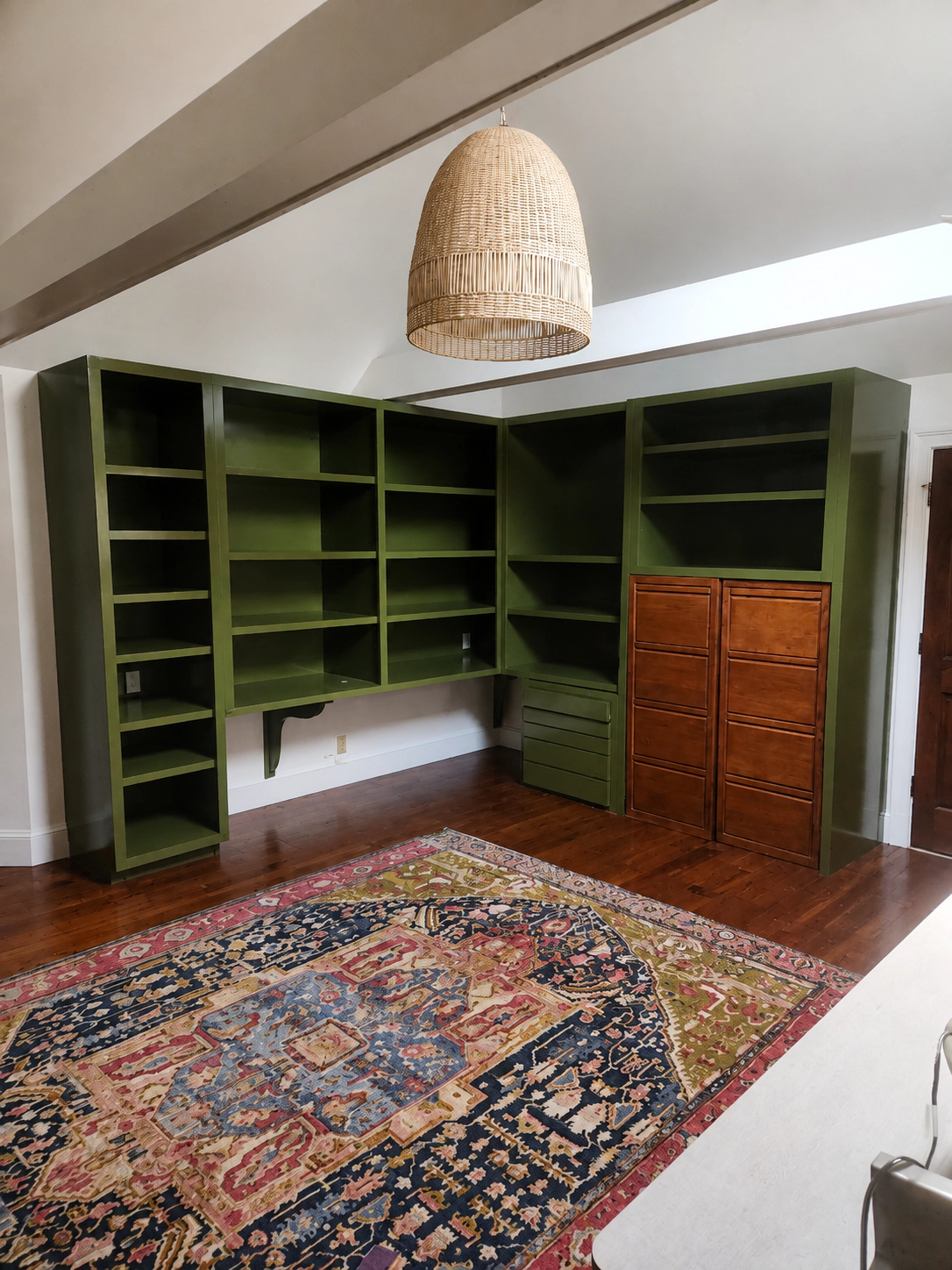 Built-in bookshelves painted Farrow & Ball Bancha green by D&D Decorators